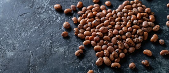 Heart shaped brown beans on black Flat lay copy space. Copy space image. Place for adding text or design