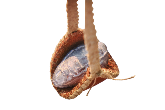 Roman slingshot of leather, isolated on a white background. Vintage weapons for throwing stones and lead, isolated on a white background. Retro outfit soldiers in ancient Rome, close-up.