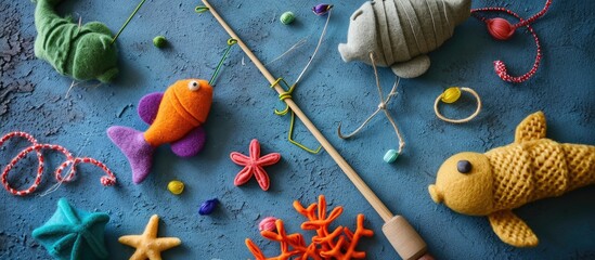 Hand made stuffed felt toy Fishing rod with magnet and fishes or other sea animals Different colors Safe eco stuffed toy for infants and toddlers Early education implement. Copy space image