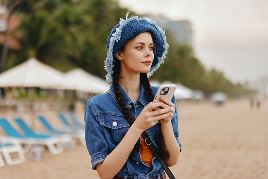 Stylish Woman Enjoying Summer at the Beach, Taking a Selfie with Phone
