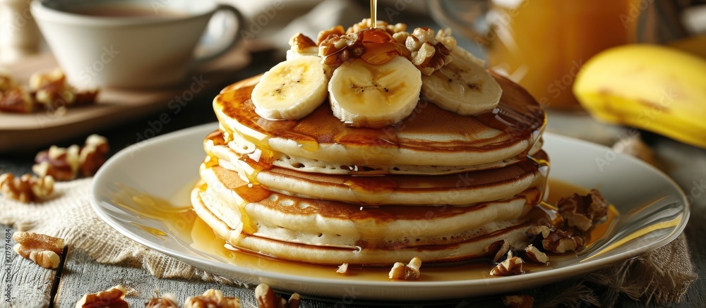 Poster Pancakes with banana walnut and caramel for a breakfast. Copy space image. Place for adding text or design