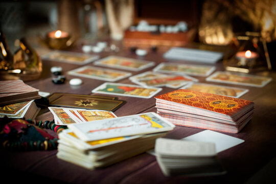 Tarot card reader arranges cards in a card spread. Fortune-telling concept