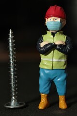miniature figurine of a worker with screws