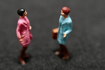 miniature figurines of a couple of women gossiping