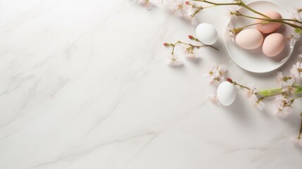 Easter eggs on a plate surrounded by cherry blossom branches on marble background.