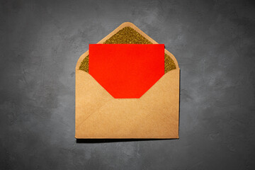 envelope with red paper inside on grey background.