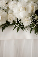 Composition of white roses and white fabric, space for writing