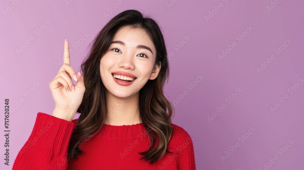 Poster A woman wearing a red sweater pointing upwards. Versatile image suitable for a variety of uses