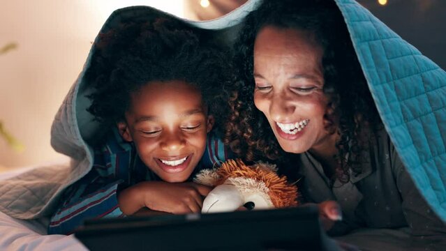 Night, tablet and mother and son on a bed with cartoon, movie or streaming funny video in their home. Digital, app and mom with kid in a bedroom for online comic, love and bonding with blanket fort