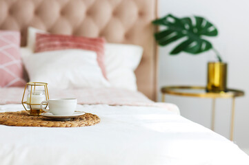 Modern bedroom with table side and pillows on the bed