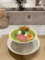 Green tea ramen noodle with beef and soft boiled egg