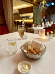 Breads butter champagne lemon water for a dinner