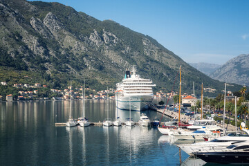Low angle view of a large cruise ship docked at the port of Kotor in Montenegro, with the...