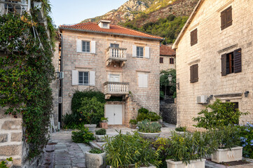 Beautiful view of an old stone house on the main promenade along the sea in the picturesque town of Perast, Bay of Kotor, Montenegro