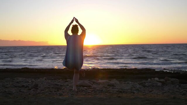 Practicing yoga at the sunset in 4k slow motion 60fps