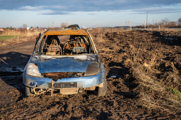 burned car wreck near to highway - 717639457