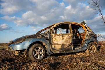 burned car wreck near to highway - 717639603