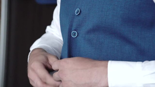 wedding, wedding men's suit, man fastens suit vest with his hands, blue, business, businessman