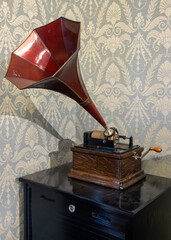 The obsolete phonograph with horn on cabinet in historical room