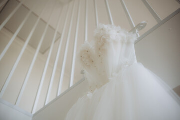 Interior of bedroom with wedding dress prepared for ceremony