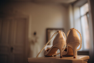 Wedding. Details. Stylish bride's shoes on the designer's table. High quality photo