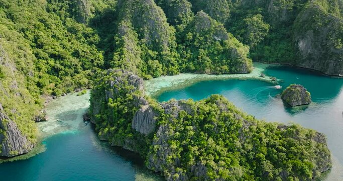 Tropical Island with boat running over the lagoons. Coron, Palawan. Philippines.