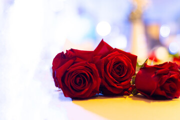 red roses on the table bokeh light background