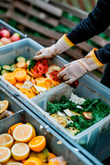 Sorting food waste into compost. Selective focus.