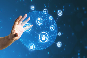 Close up of businessman hand using creative connected digital business interface with various icons and binary code on blurry background. Software development, app, global business and ai concept.