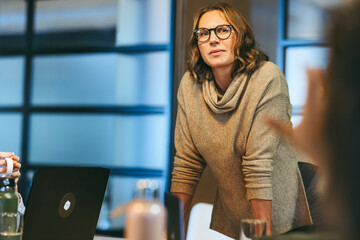 Professional business woman leading creative team in tech startup office