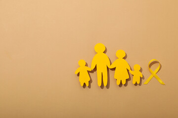 Paper figures of a family with a yellow ribbon