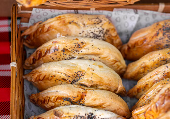 Homemade Chicken, beef, or cheese cheese-stuffed empanadas sold at the farmers market - 717687034