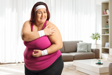 Fototapeta na wymiar Plus size woman holding her painful elbow