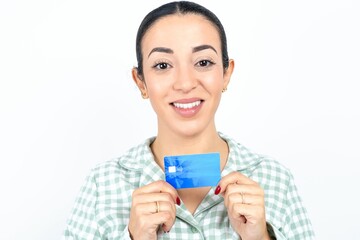 Photo of Beautiful young woman wearing green plaid pyjama and holding a cup positive smile hold credit card income salary