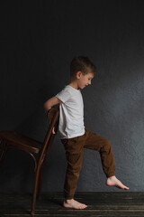 blond boy in a white T-shirt, blurred background, bokeh