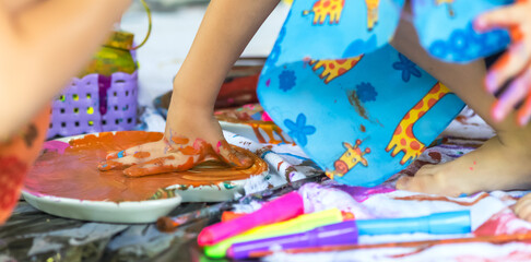 Young artist girl with dirty hand in art school