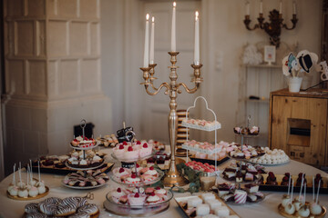 Candybar table full of sweets in a rustic place