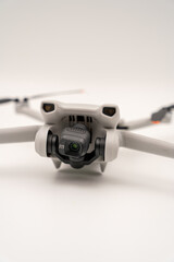 four-winged camera drone in front of a white background to camera