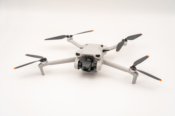 four-winged camera drone in front of a white backgroundisolated