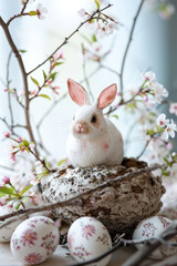 Naklejka na ściany i meble White Bunny Sitting in Nest With Eggs - Adorable Spring Photo