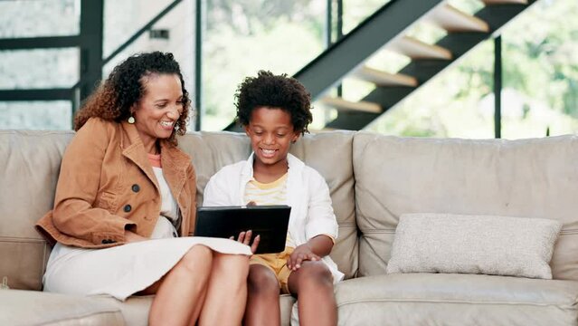 Happy mother, child and tablet on sofa for entertainment, online streaming or social media at home. African mom, kid or little boy smile with technology for bonding, movie or relax in living room