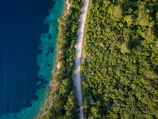 Aerial viewpoint of a road next to the sea during sunset. Travel concept.