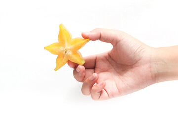 Hand holding sliced and whole fresh organic star fruit delicious isolated on white background clipping path