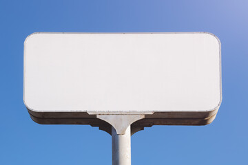 Blank faded old billboard, space for advertising text against background of blue sky