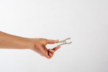 Close up of clothes peg in hand on white background