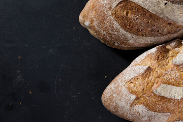 Rustic bread loaf on Black Slate Board.