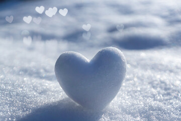 A snowy, tender heart against a winter background with beautiful bokeh. - obrazy, fototapety, plakaty