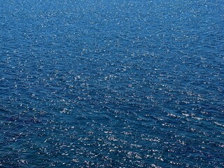 Blue water glittering calm surface. 