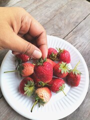 Fresh red strawberries on hand