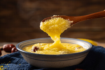 millet congee or millet porridge with jujube in a bowl  on tabe.